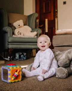 A baby girl and her toys during Mum and Me photoshoot by Sophie Ransome Lifestyle Photographer