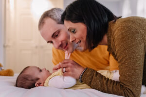 Mum and dad play with their baby, family photograph by Sophie Ransome Lifestyle Photographer