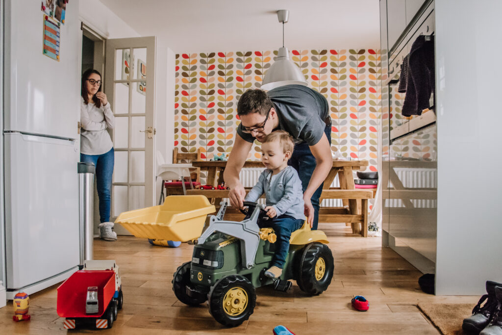 A father and his son play while Mum looks on, Award winning family image taken by Sophie Ransome Lifestyle Photographer