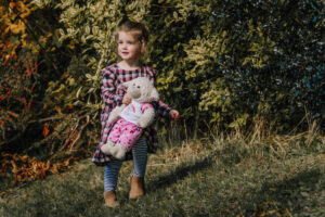 A girl and her bear at the park taken by Sophie Ransome Lifestyle Photographer