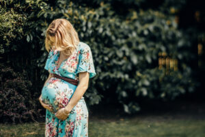 Mum to be cradles her bump Maternity image by Sophie Ransome Lifestyle Photographer