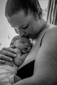 Black and white newborn image of mum and baby by Sophie Ransome Lifestyle Photographer
