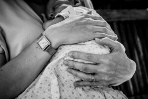 Mums hands cradle newborn. Black and white image by Sophie Ransome Lifestyle Photographer
