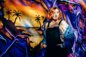A teen girl infront of a wall of graffiti art taken by Sophie Ransome Lifestyle Photographer